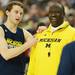 Michigan freshman Nik Stauskas chats with assistant coach Bacari Alexander during an open practice at the Georgia Dome in Atlanta on Friday, April 5, 2015. Melanie Maxwell I AnnArbor.com